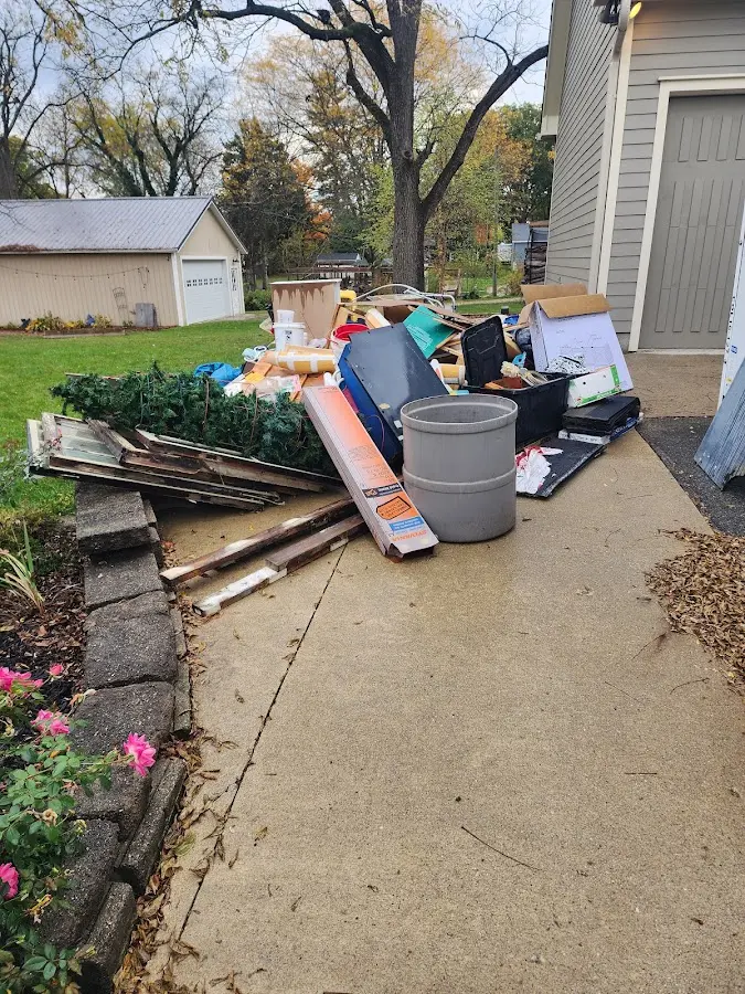 Dumpster being loaded with debris for Estate Cleanout Dumpster Rental in Nitro